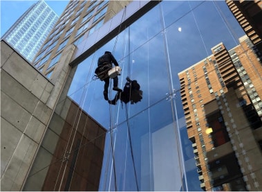 Top Team window cleaning on a rope on the cleaning facade of a skyscraper